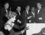 The real Rat Pack — Peter Lawford (left), Frank Sinatra, Dean Martin, Sammy Davis Jr. and Joey Bishop — clown around onstage during a show at the Sands Hotel in Las Vegas on Jan. 20, 1960. The woman at left is unidentified.
